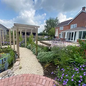 a garden with flowers and a brick walkway