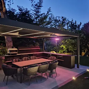 a patio with a table and chairs and a grill