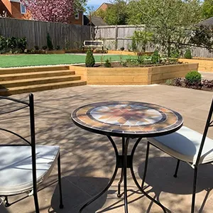 a small patio with a table and chairs